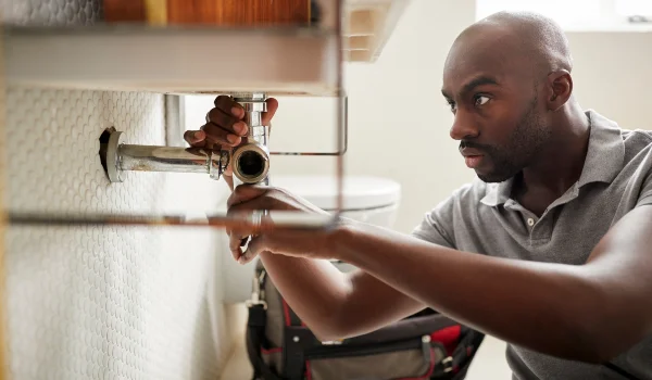 a male plumber fixing a bathroom faucet in Cedar Park, TX - Cedar Park, TX a male plumber fixing a bathroom faucet in Cedar Park, TX - Cedar Park, TX